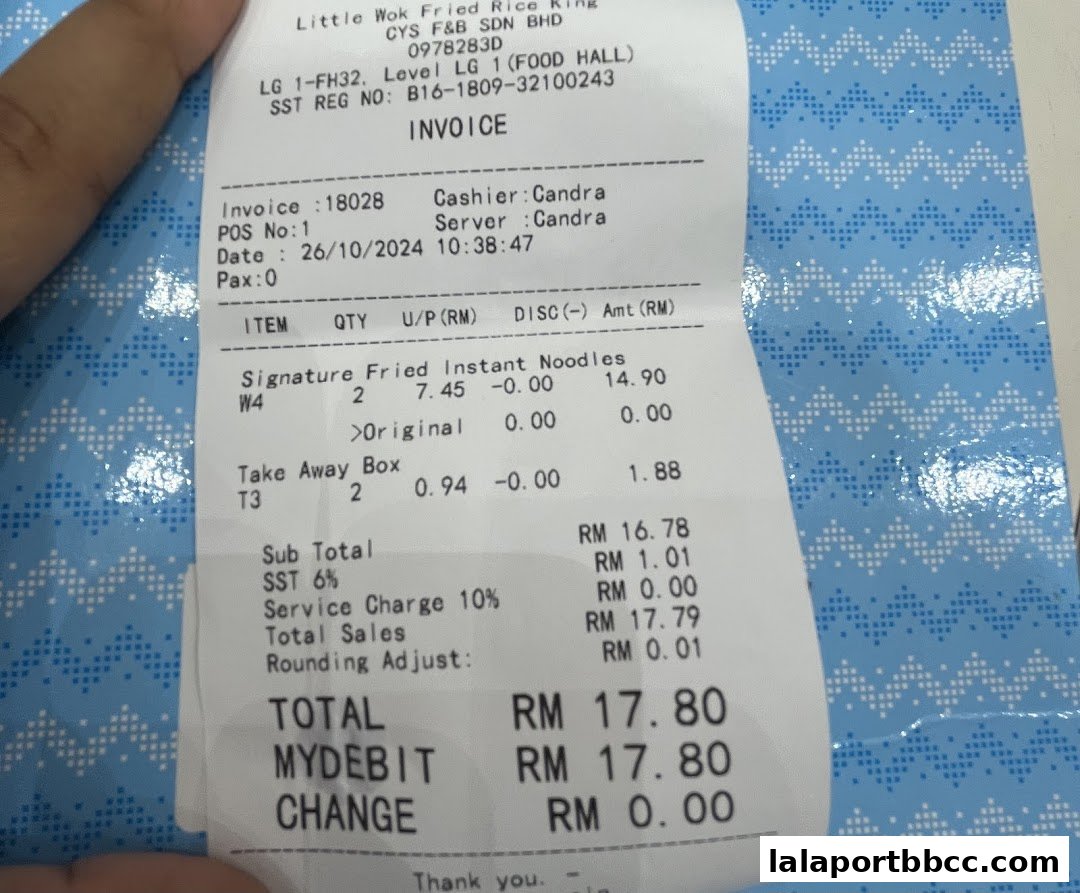 A receipt from Little Wok Fried Rice King showing purchased items and total cost.