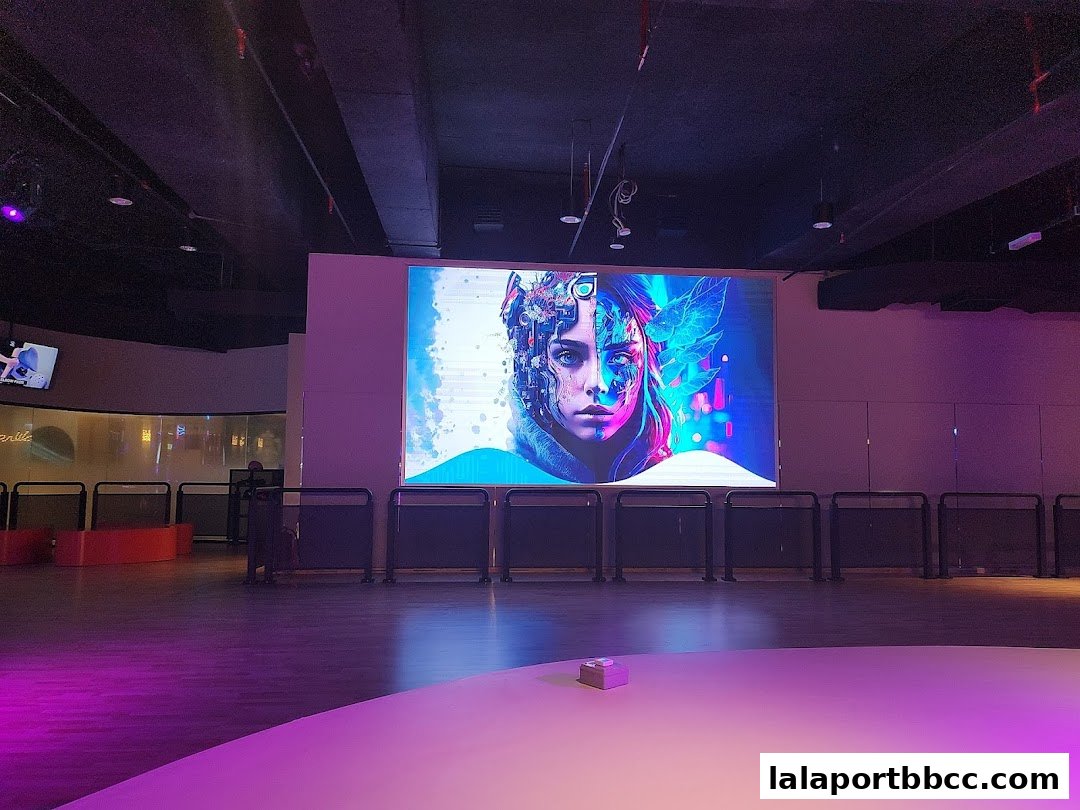 A large digital screen displays a futuristic portrait of a woman with mechanical and natural elements.