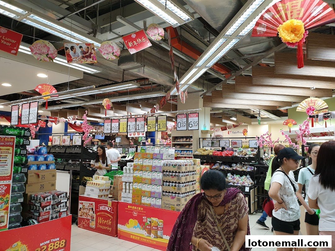 Interior of a FairPrice supermarket decorated for Lunar New Year with festive banners and products.
