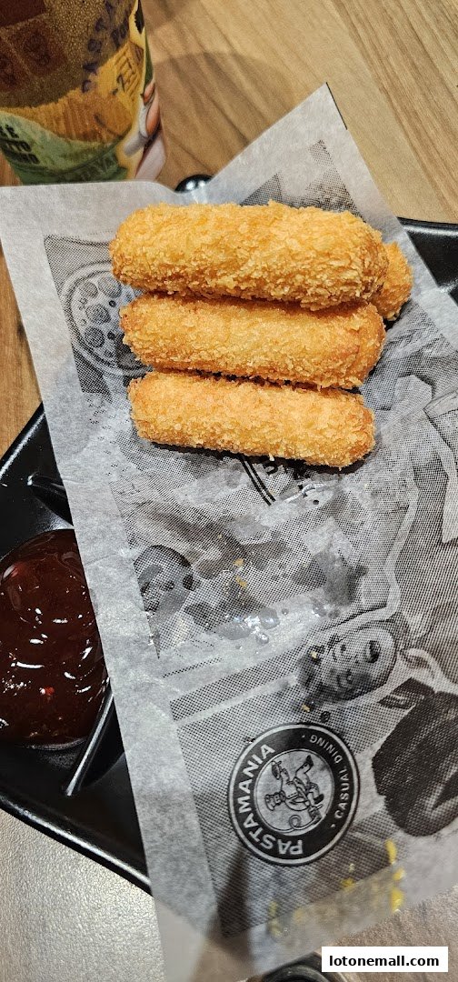 Crispy fried mozzarella sticks served with a side of marinara sauce.