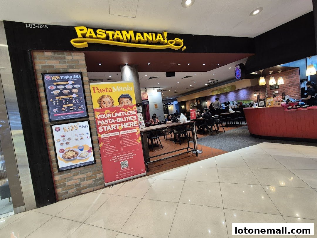 The entrance of PastaMania, an Italian casual dining restaurant, with promotional posters displayed.