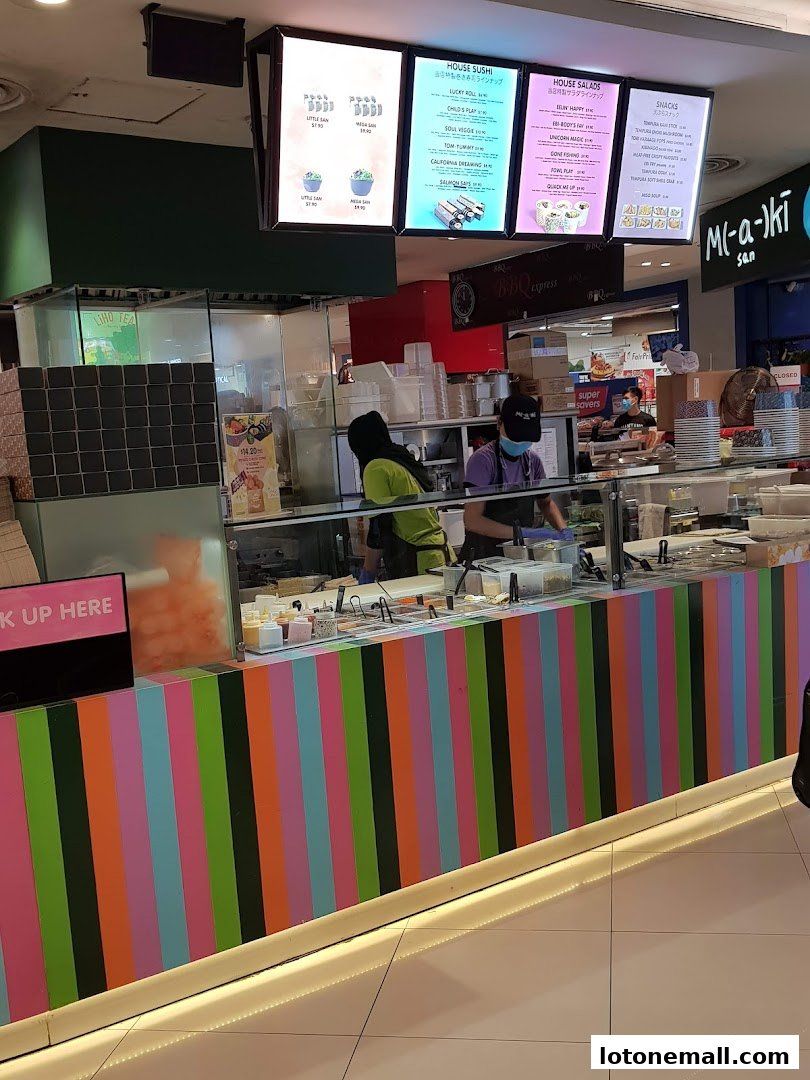 A food stall with colorful stripes and illuminated menus displaying sushi, salads, and snacks.