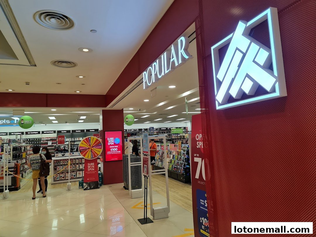 The entrance to POPULAR Bookstore, featuring a promotional spin wheel and sale signage.