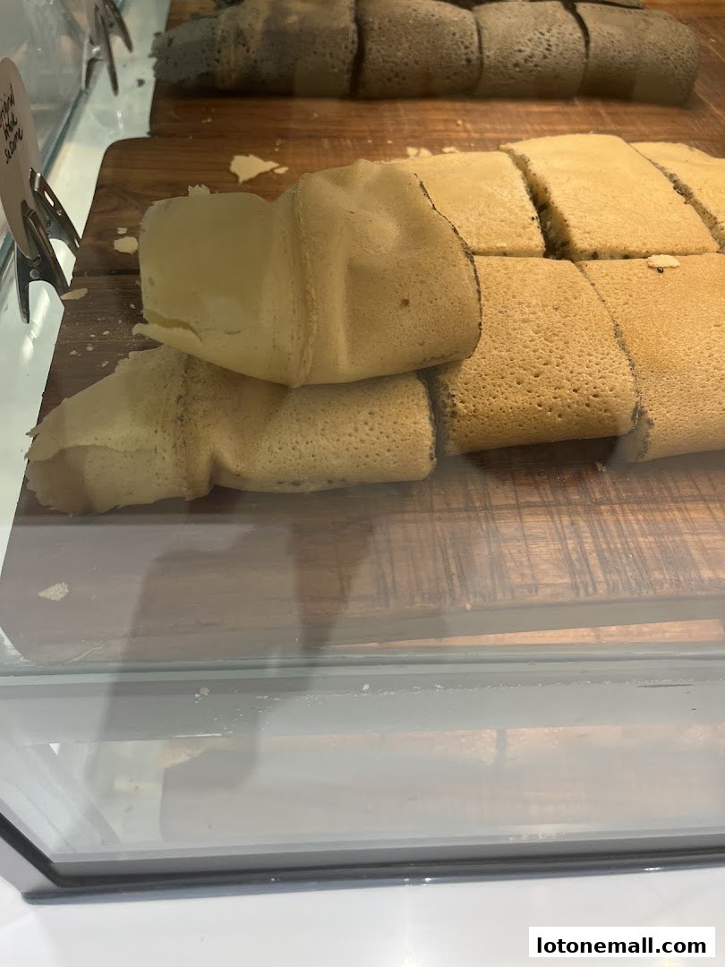Close-up of freshly made pancakes displayed in a glass case.