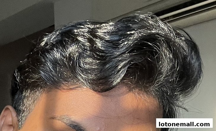 Close-up of a person's dark, styled hair with a slight shine.