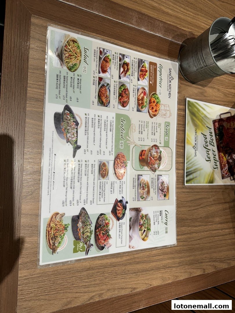 A menu from Sanook Kitchen featuring Thai dishes like salads, appetizers, seafood, soup, and curry.