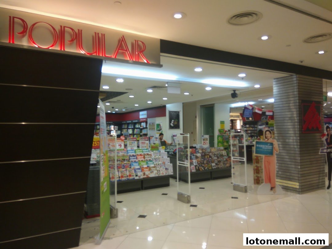 The entrance of POPULAR Bookstore, showcasing a wide selection of books and magazines.