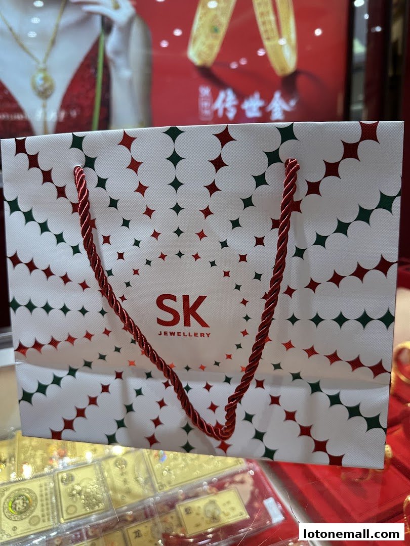 A branded shopping bag from SK Jewellery with a festive star pattern.