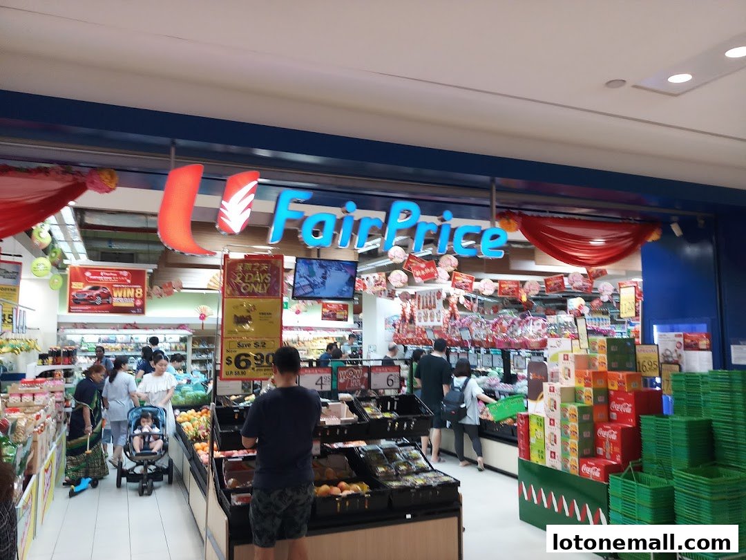 Customers shop at FairPrice supermarket with displays of fruits, drinks, and promotional signs.
