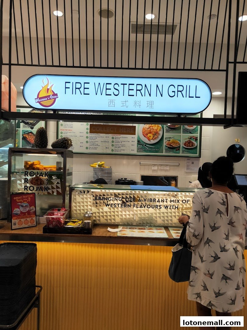 A food court stall with a sign for 'Fire Western N Grill' and a display of food items.