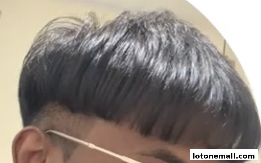 Close-up of a person's dark, styled hair with a fade haircut.