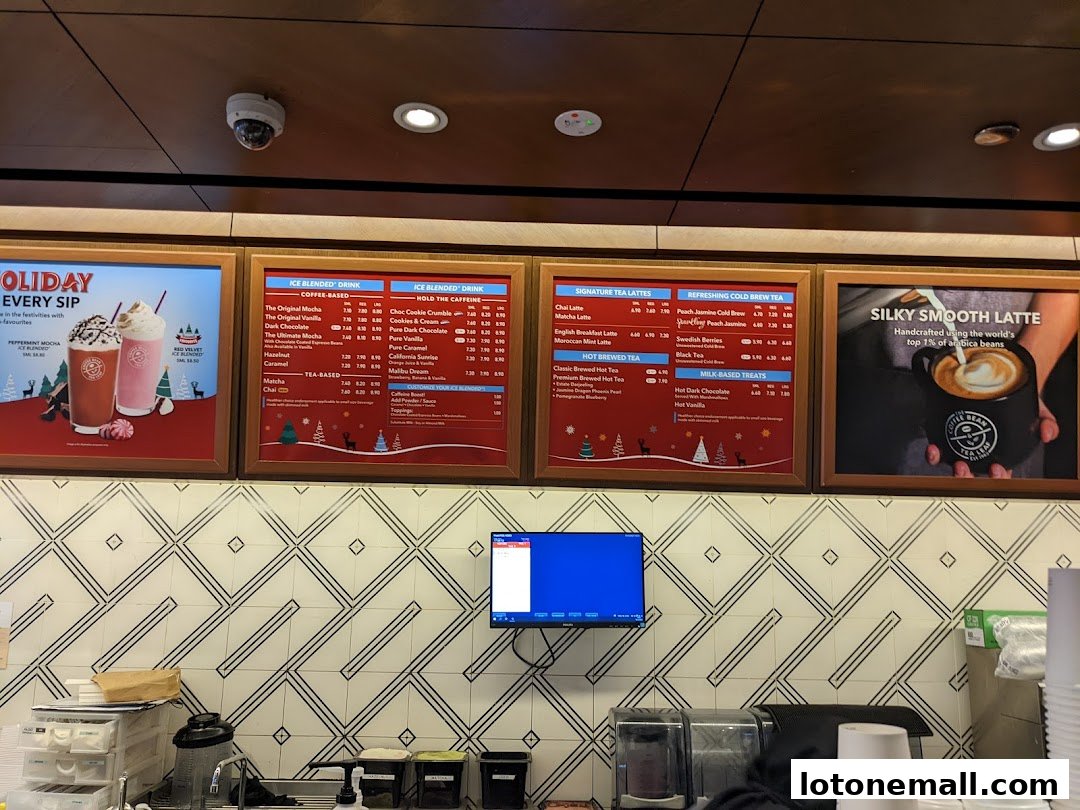 A menu board displaying various coffee and tea drinks with prices.