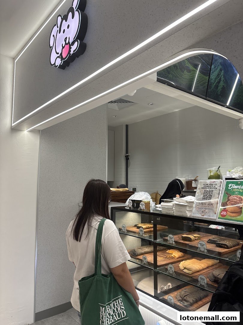 A customer stands in front of a display case filled with various pancakes at Munchi Pancakes.