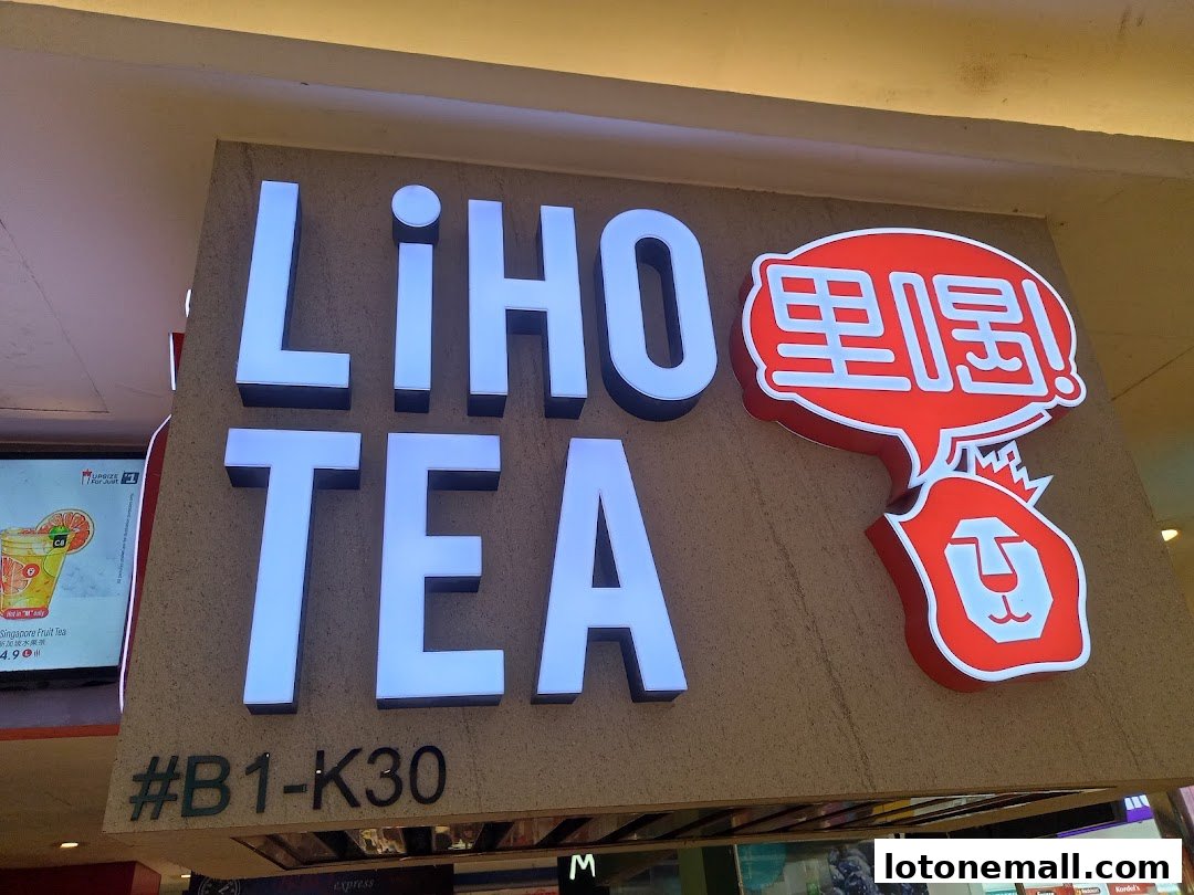 The illuminated sign for LiHO TEA, featuring the brand name and a lion logo.