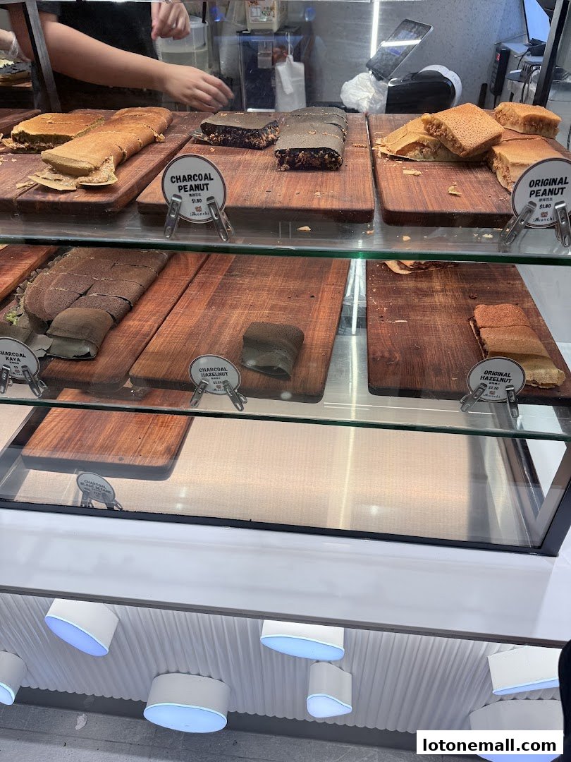 A display case filled with various types of pancakes, some with charcoal and peanut fillings.