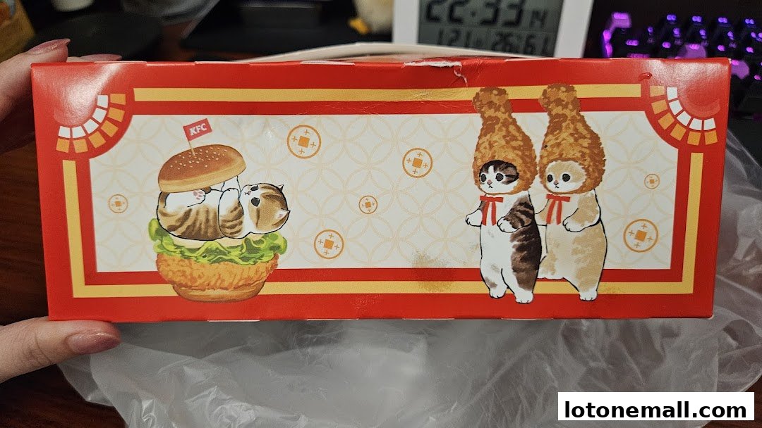 A red KFC box featuring cute cat illustrations with burgers and fried chicken.