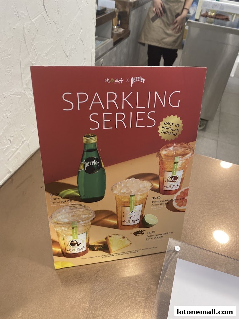 A menu board advertising CHICHA San Chen's Sparkling Series featuring Perrier drinks.