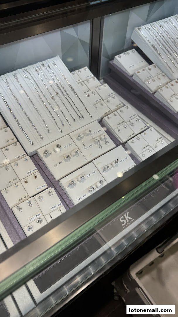 A display case filled with various necklaces and earrings from SK Jewellery.