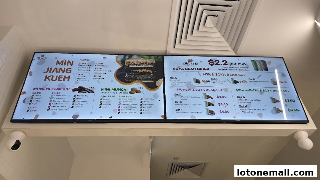 A digital menu board displaying various pancake and soya bean drink options with prices.