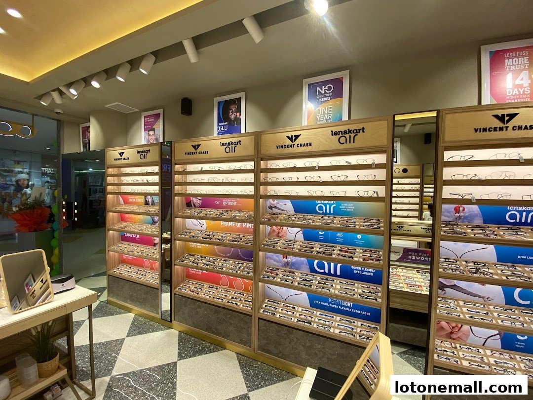 Interior view of a Lenskart store showcasing various eyewear collections on display shelves.