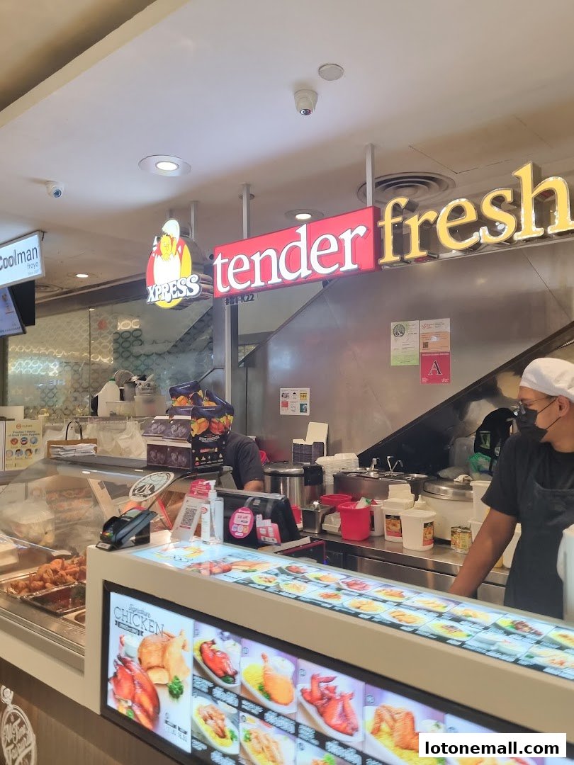 A food stall with a display of various chicken dishes and a menu board.
