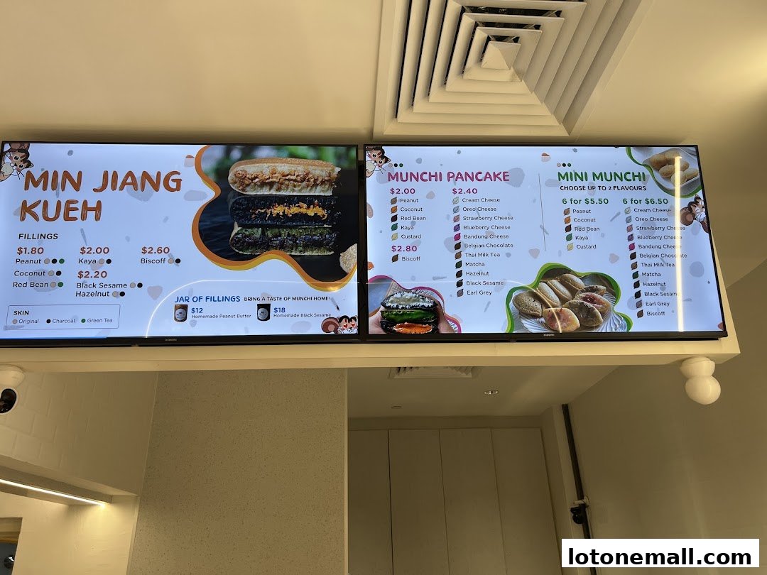 A digital menu board displaying various pancake options and fillings with prices.