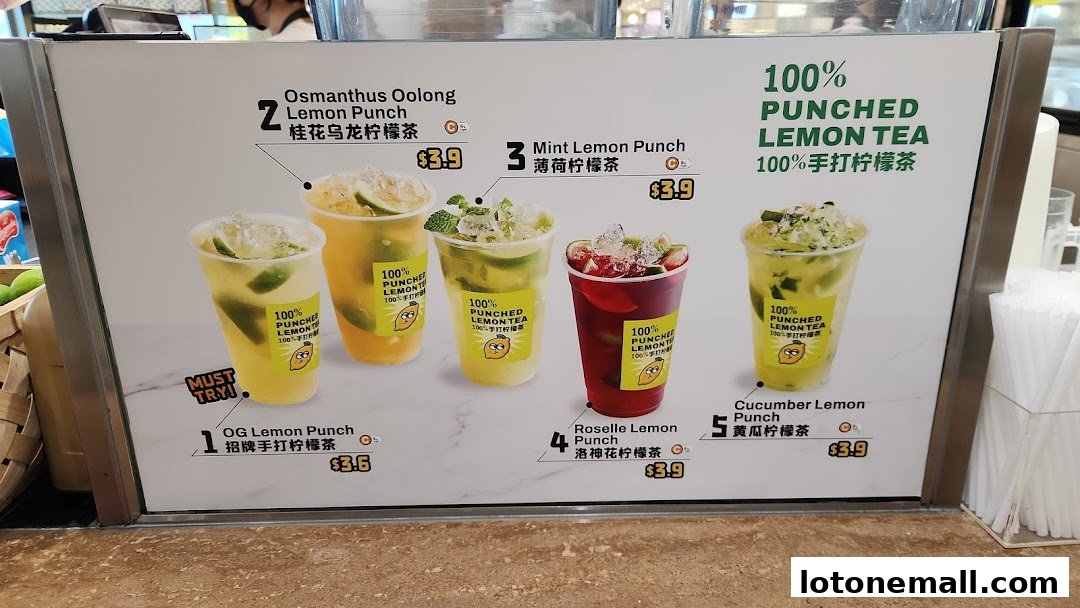 A menu board displaying various flavors of 100% Punched Lemon Tea with prices.