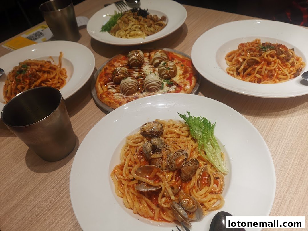 A table laden with delicious Italian dishes, including pasta and pizza, ready to be enjoyed.