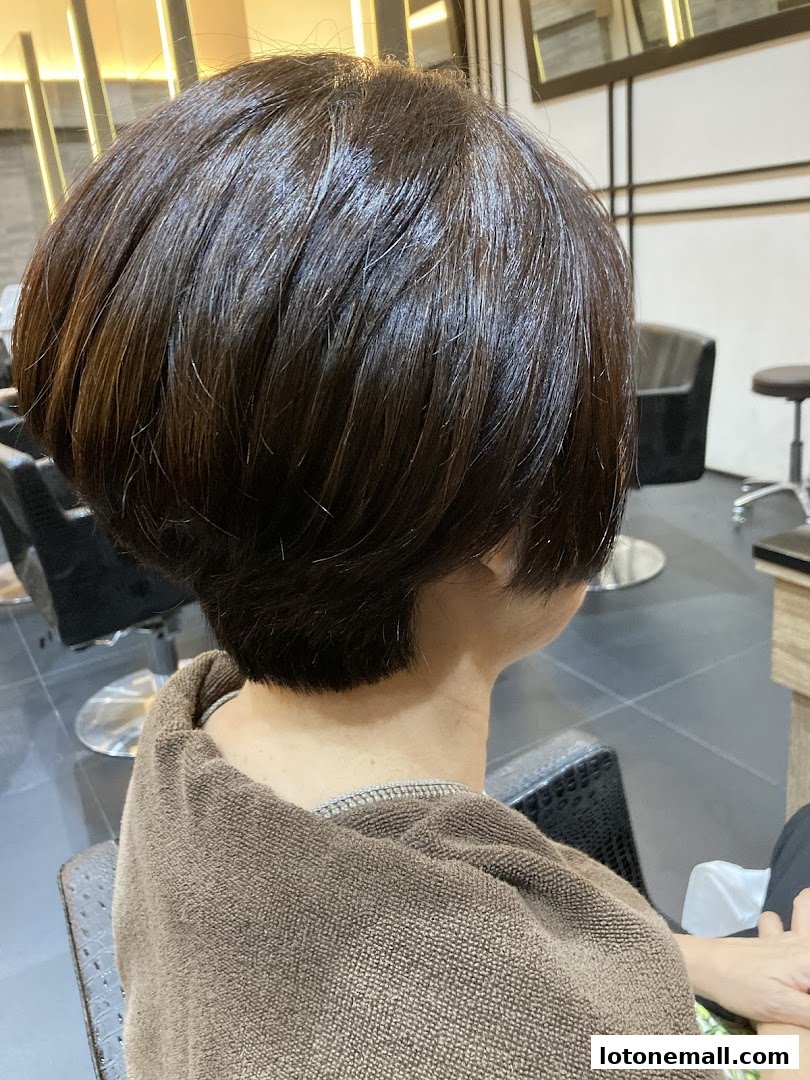 A person with a fresh, stylish bob haircut in a salon chair.