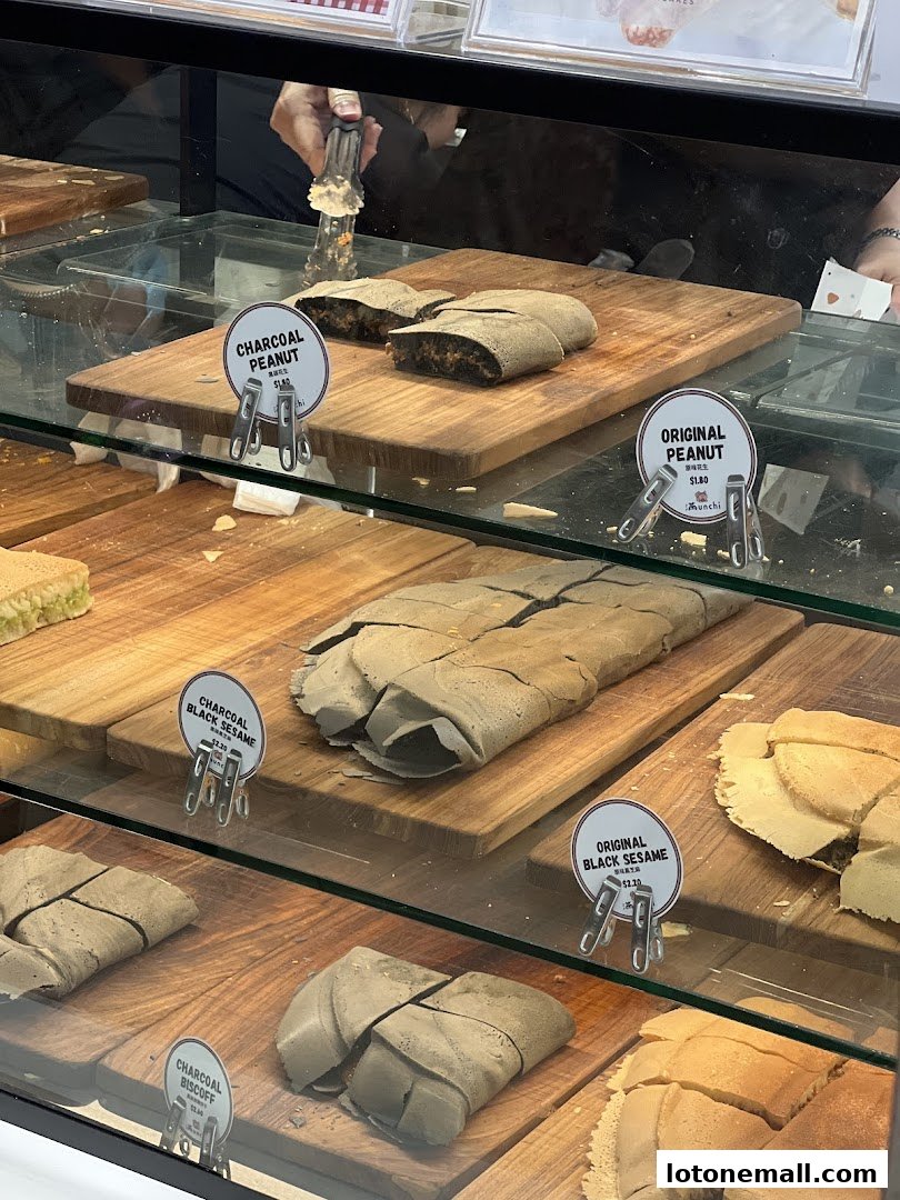 Display case filled with various flavors of pancakes, some with charcoal coloring.