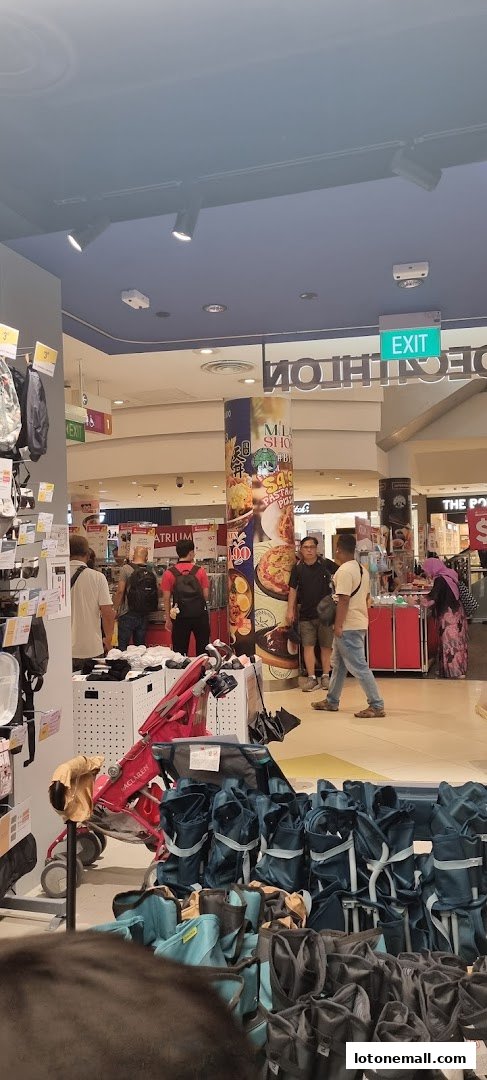 Interior view of a Decathlon store with various sports equipment and shoppers.