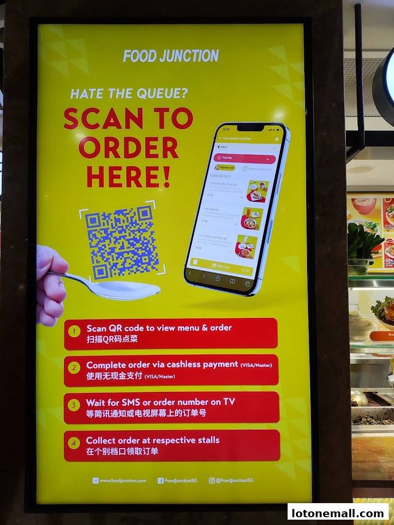 A sign at Food Junction shows how to scan a QR code to order food and avoid queues.