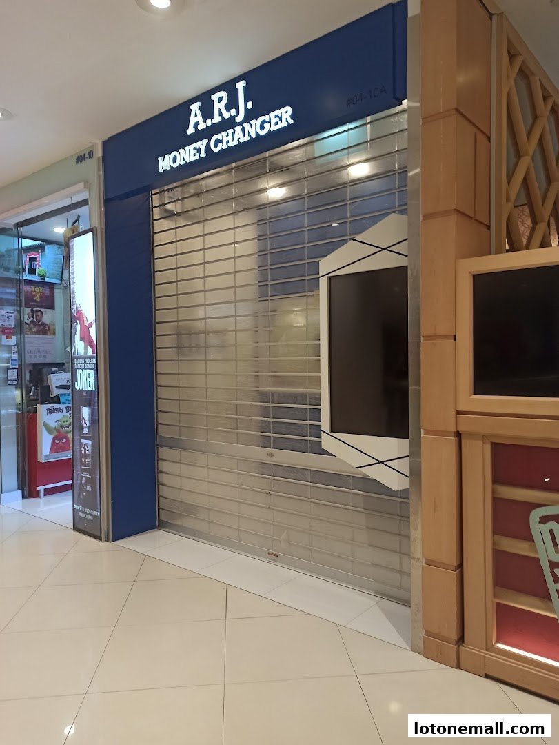 The exterior of A.R.J. Money Changer shop with its shutter down.