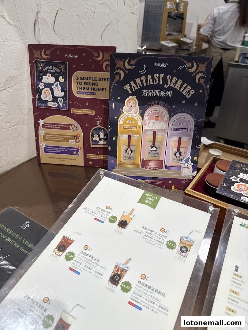 A display of bubble tea drinks and promotional materials for a 'Fantasy Series'.