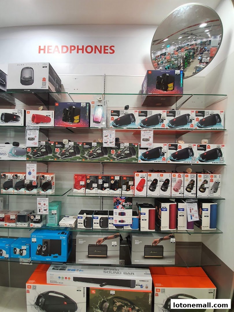 Shelves filled with various audio devices including headphones, speakers, and soundbars.