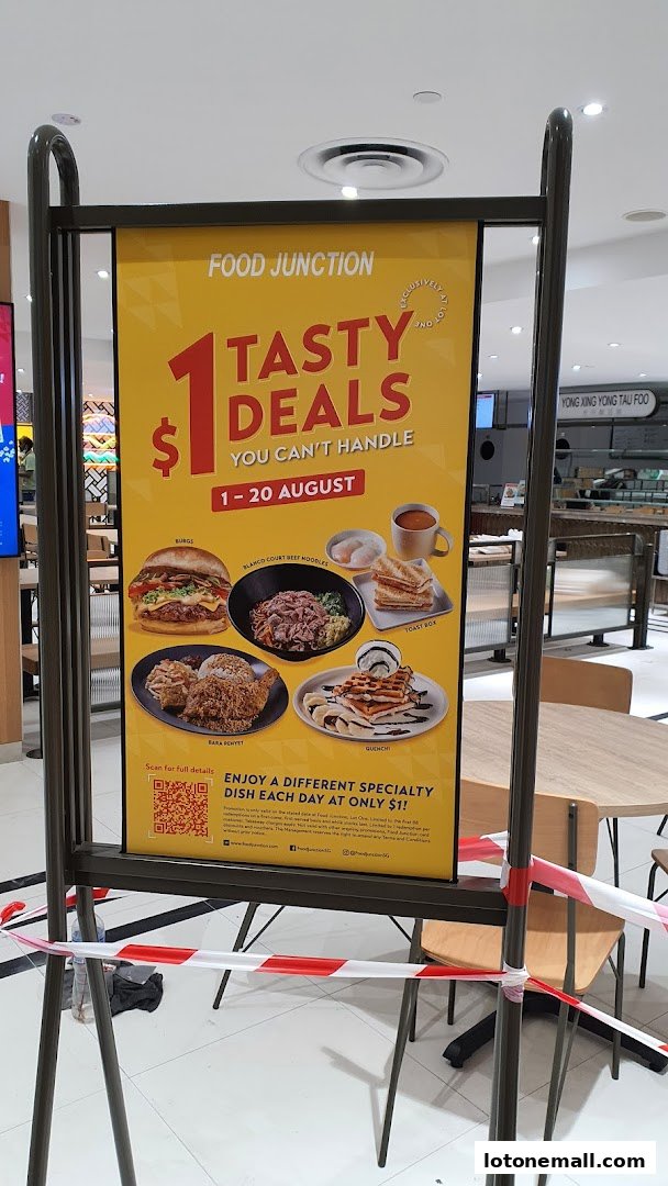 A promotional sign for Food Junction advertising $1 tasty deals on various dishes.