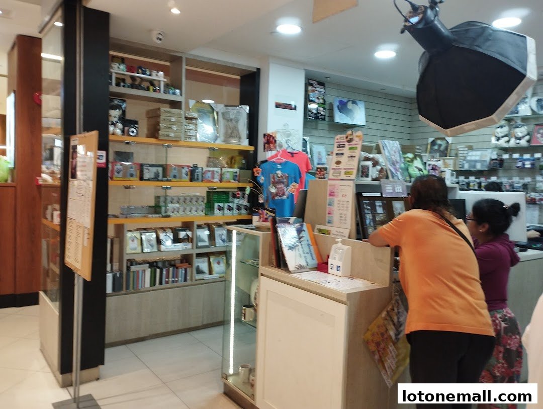 Interior of a Kodak Express shop with shelves stocked with cameras and photo-related items.