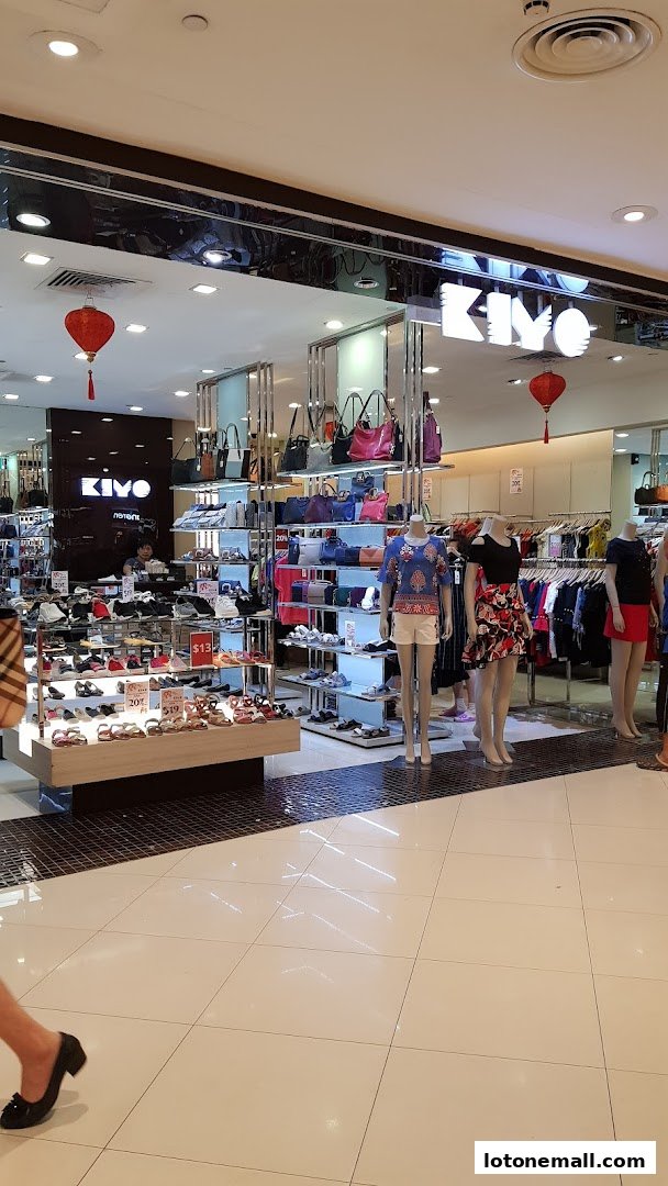 A well-lit fashion store interior displaying shoes, handbags, and clothing on mannequins.