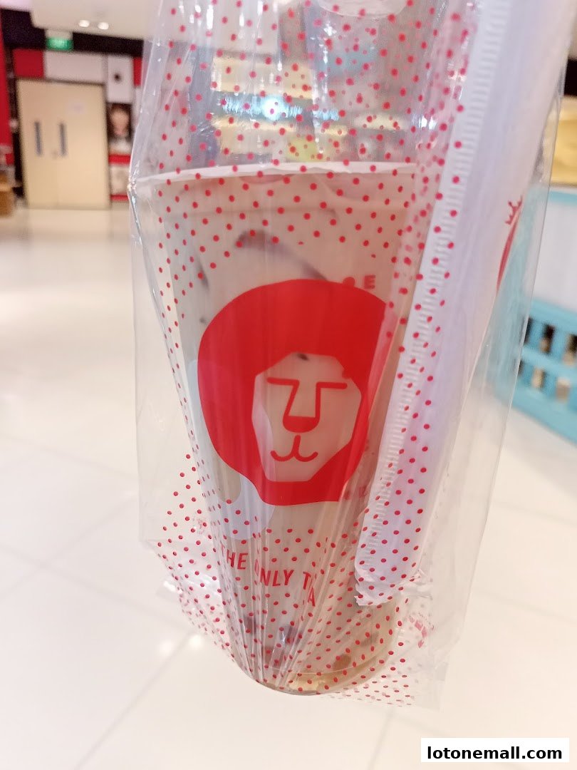 A close-up of a LiHO TEA drink in a plastic bag with red polka dots.