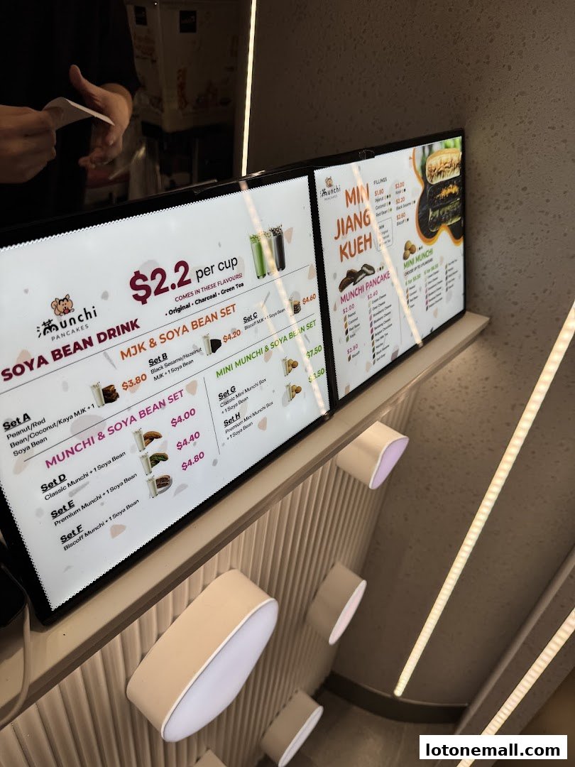 Digital menu boards displaying Soya Bean drinks and Munchi Pancakes with various sets and fillings.