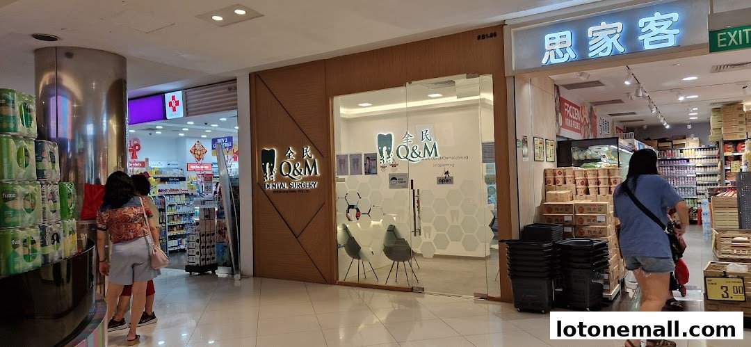 The entrance to Q&M Dental Surgery, a modern clinic with glass doors and interior seating.