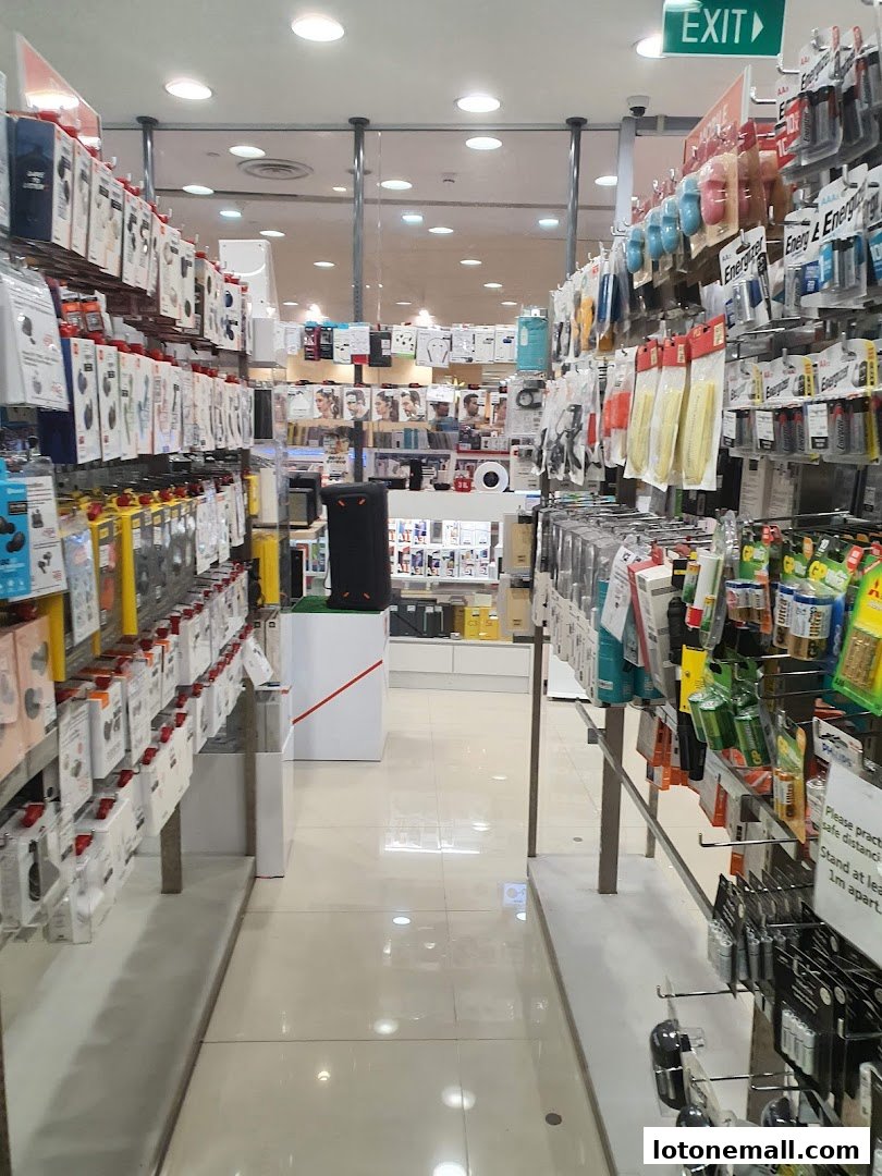 Aisle view of a retail store selling electronics and accessories, with products displayed on shelves.