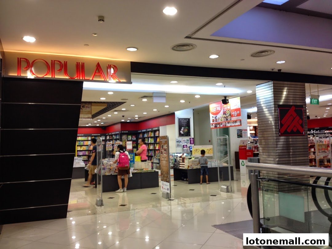 Interior view of a POPULAR bookstore with shelves of books and customers browsing.