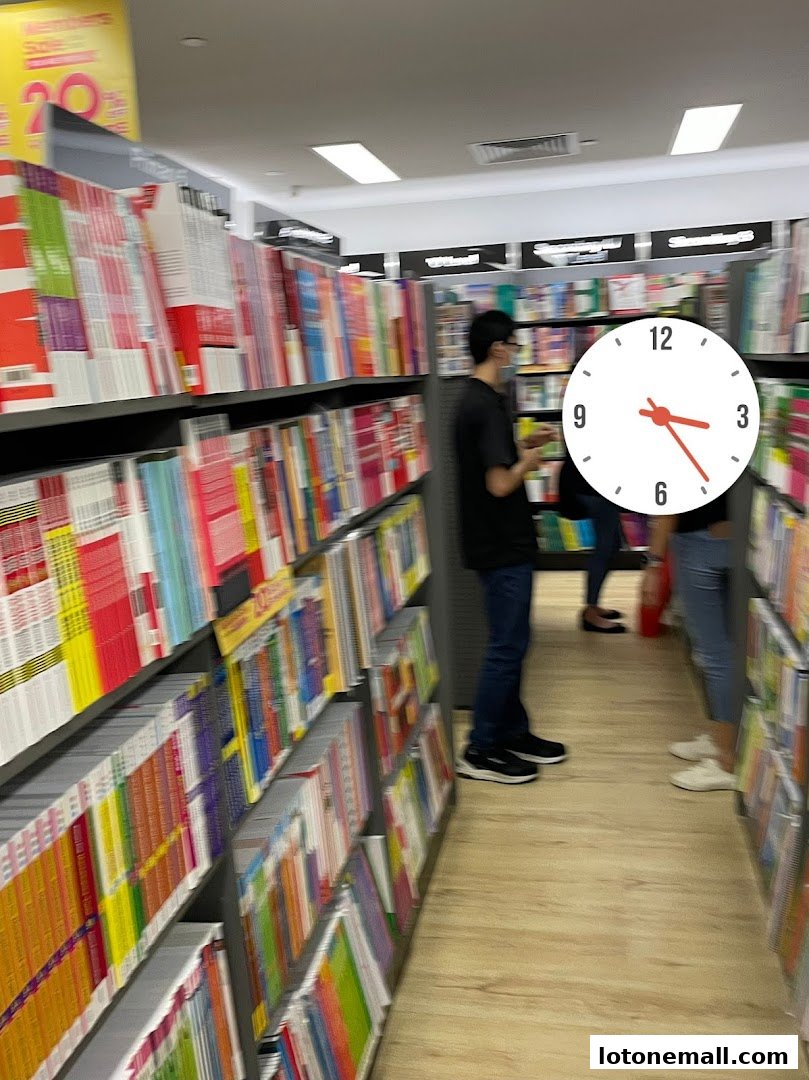A bookstore aisle filled with books, with customers browsing.