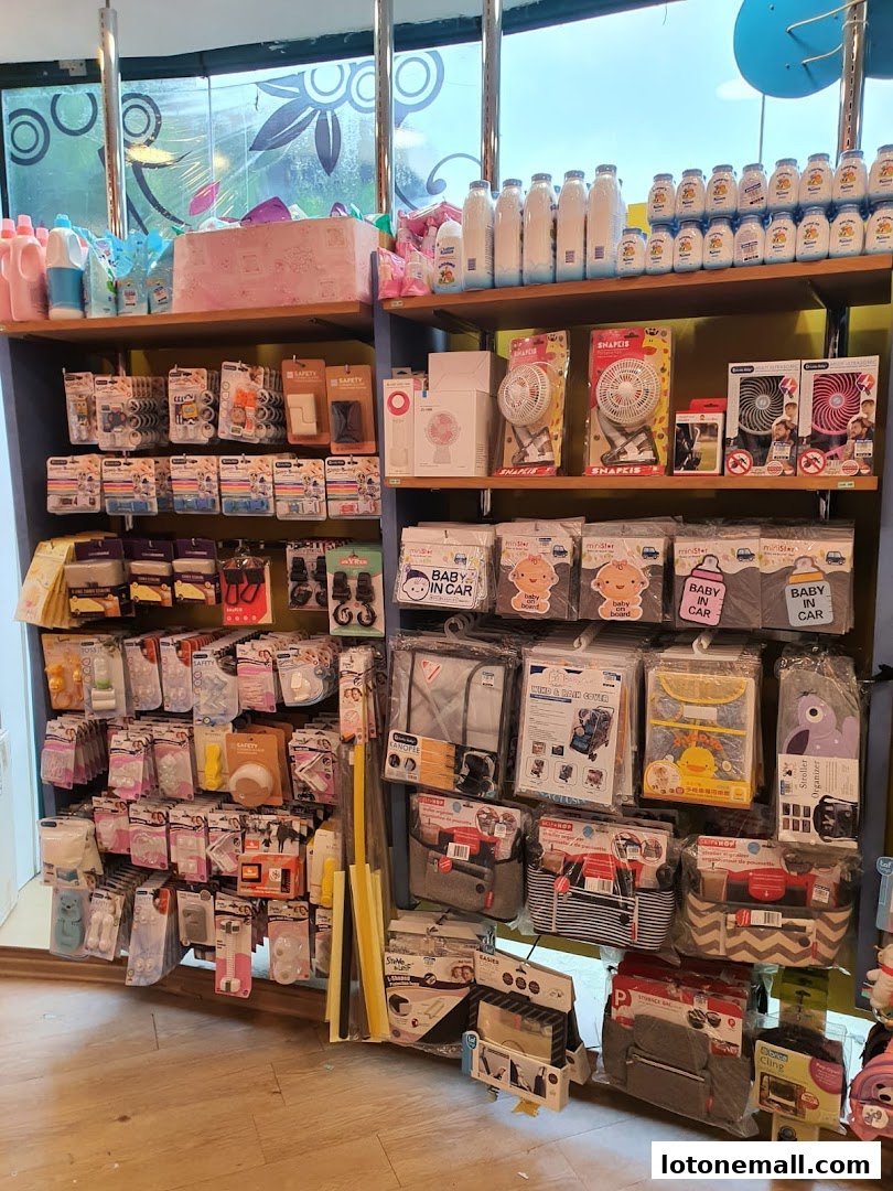 Shelves stocked with baby products including bottles, fans, car seat accessories, and organizers.