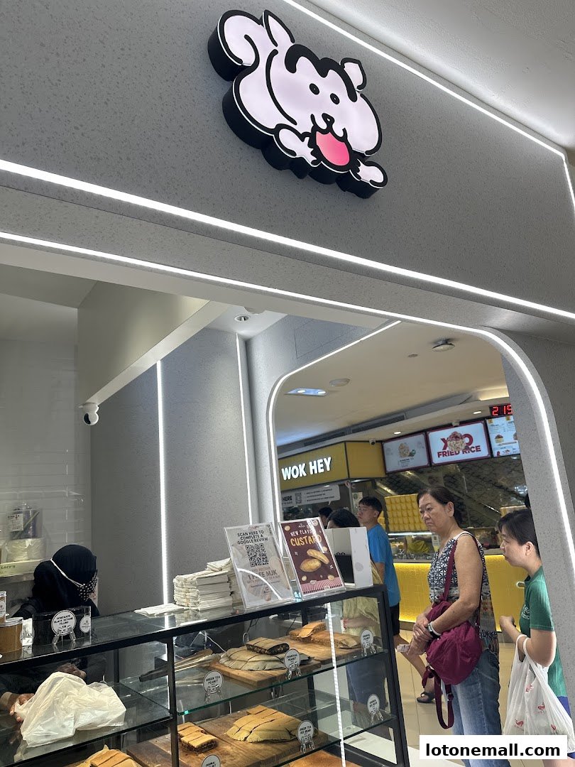 Customers at the counter of Munchi Pancakes, with pancakes displayed in the showcase.