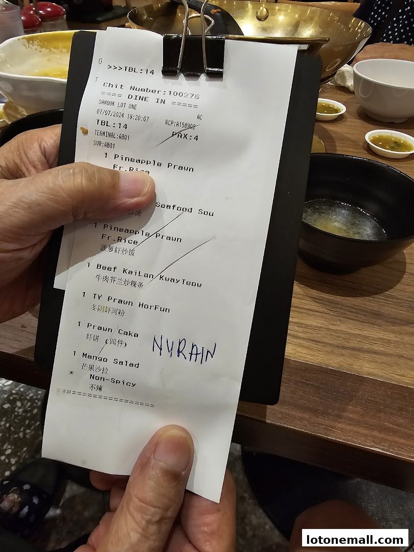 A receipt from Sanook Kitchen showing a list of ordered food items.