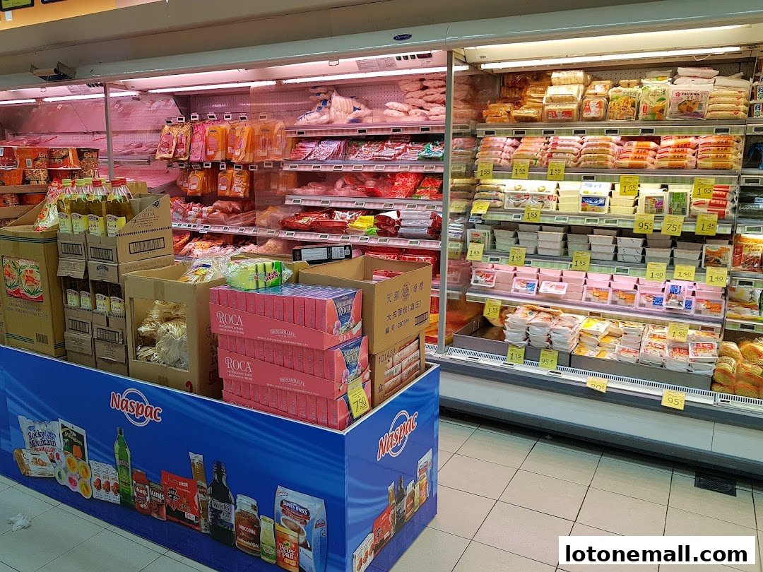 A wide selection of chilled food products displayed in refrigerated shelves at a supermarket.