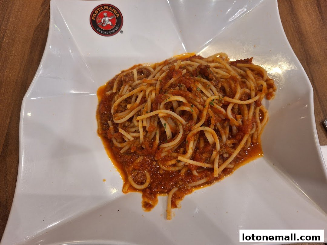 A plate of spaghetti bolognese served at PastaMania, a casual Italian dining restaurant.