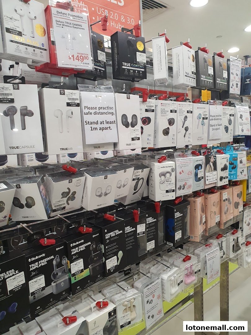 A retail display showcasing a wide variety of wireless earphones and audio accessories.